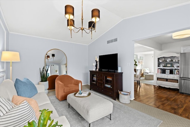 living room featuring an inviting chandelier, hardwood / wood-style floors, and lofted ceiling