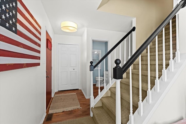 stairway with hardwood / wood-style floors