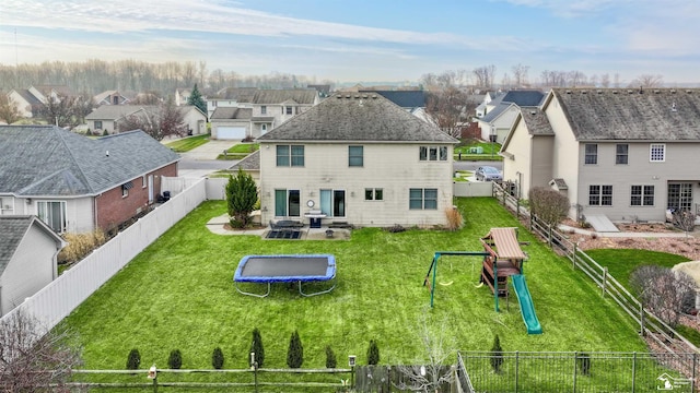 back of house featuring a lawn, a playground, a trampoline, and a patio