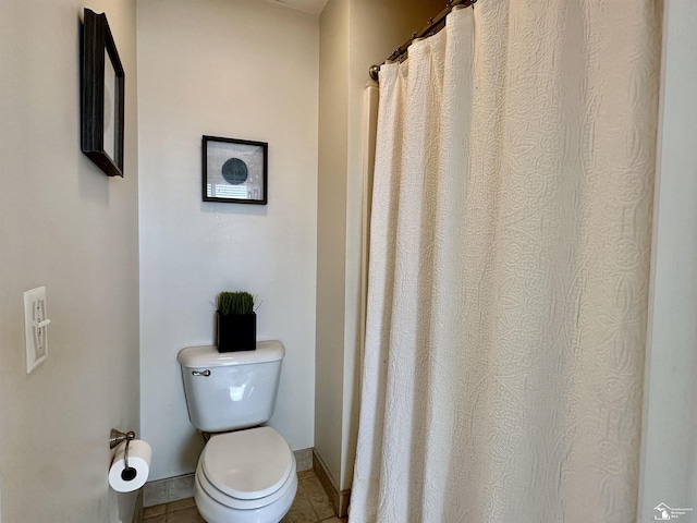 bathroom with tile patterned floors and toilet