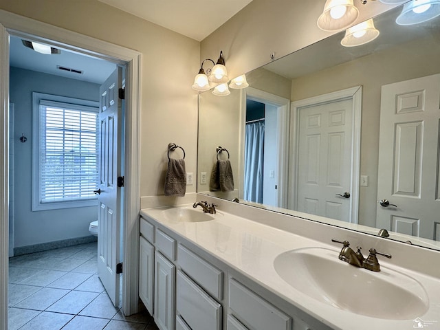 bathroom featuring vanity, tile patterned floors, and toilet