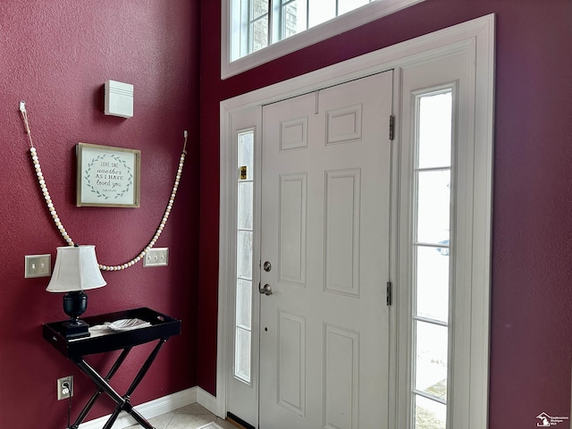 tiled foyer featuring plenty of natural light