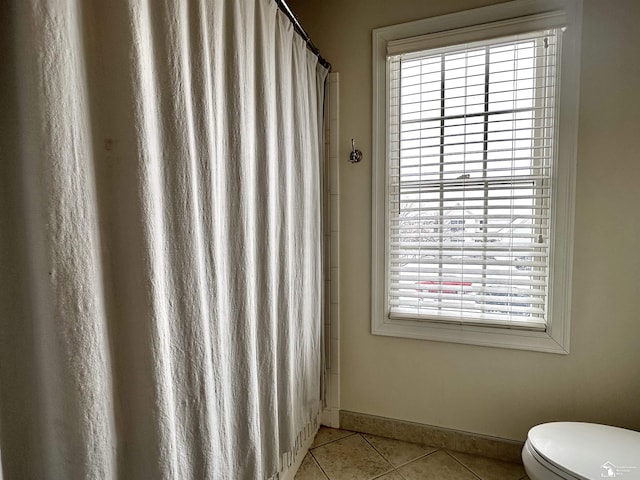 bathroom with toilet and tile patterned flooring