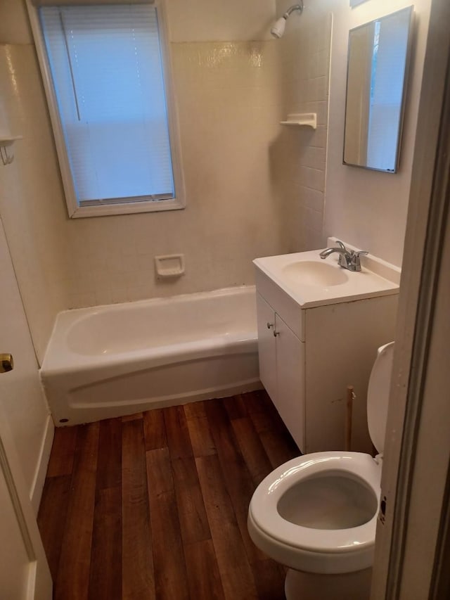 full bathroom with toilet, vanity, shower / washtub combination, and hardwood / wood-style floors