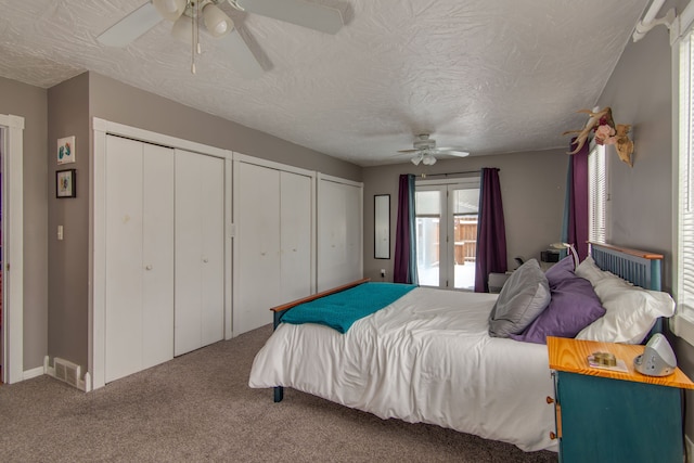 bedroom with carpet floors, a textured ceiling, and ceiling fan