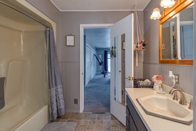 bathroom with vanity, ornamental molding, a textured ceiling, and shower / bath combo with shower curtain