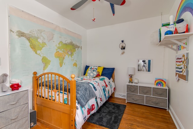 bedroom with wood-type flooring and ceiling fan