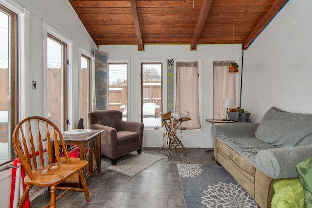 sunroom featuring lofted ceiling with beams, a healthy amount of sunlight, and wood ceiling