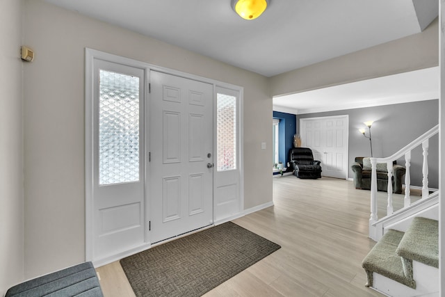 entrance foyer featuring light hardwood / wood-style floors and a healthy amount of sunlight