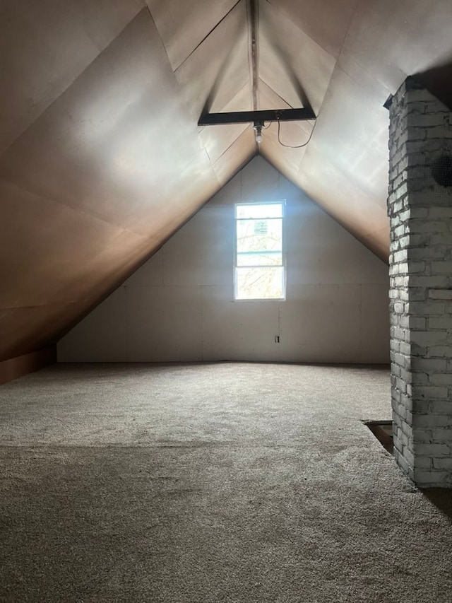 additional living space featuring lofted ceiling and carpet