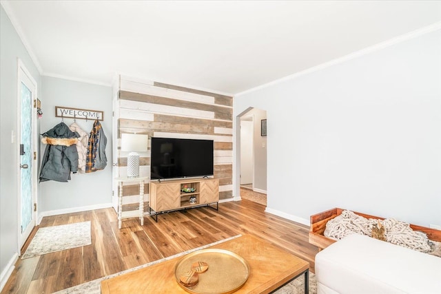 living room featuring ornamental molding, a healthy amount of sunlight, and hardwood / wood-style flooring