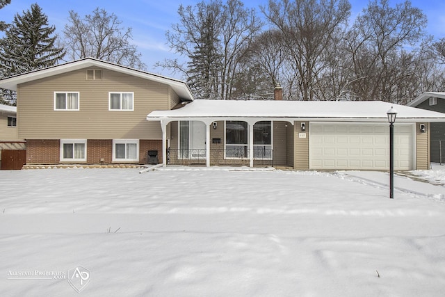 split level home with a garage and a porch