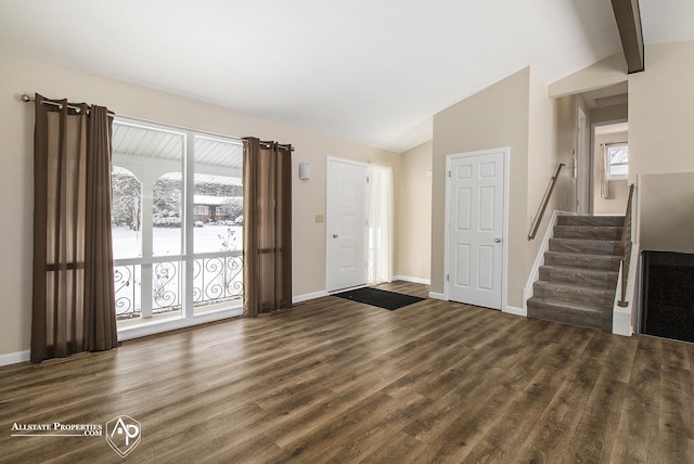 entryway featuring dark hardwood / wood-style flooring and vaulted ceiling with beams