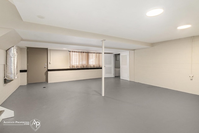 finished basement featuring concrete block wall