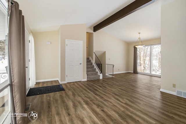 foyer entrance featuring dark wood-type flooring and vaulted ceiling with beams