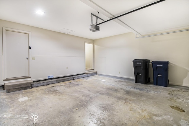 garage featuring a garage door opener and baseboards