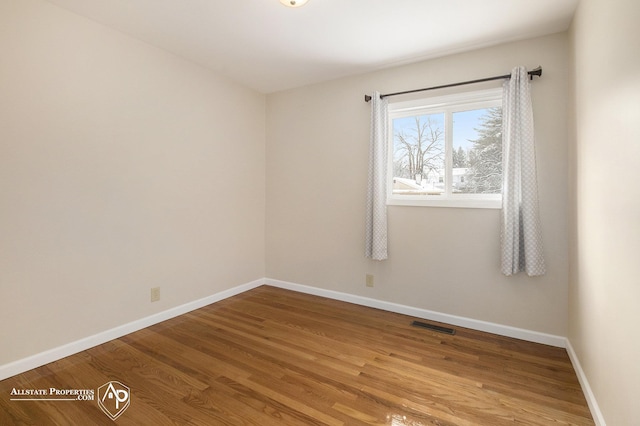empty room with wood finished floors and baseboards