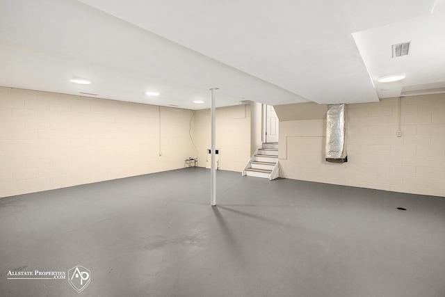 finished below grade area with stairway and concrete block wall