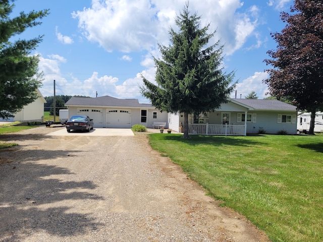 ranch-style house featuring a front yard, covered porch, and a garage