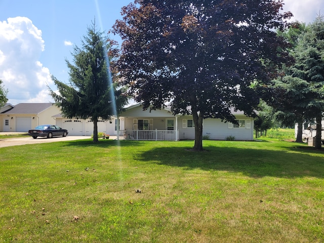 view of yard with a garage and covered porch