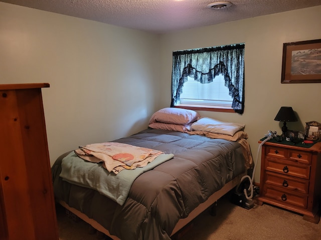 carpeted bedroom with a textured ceiling