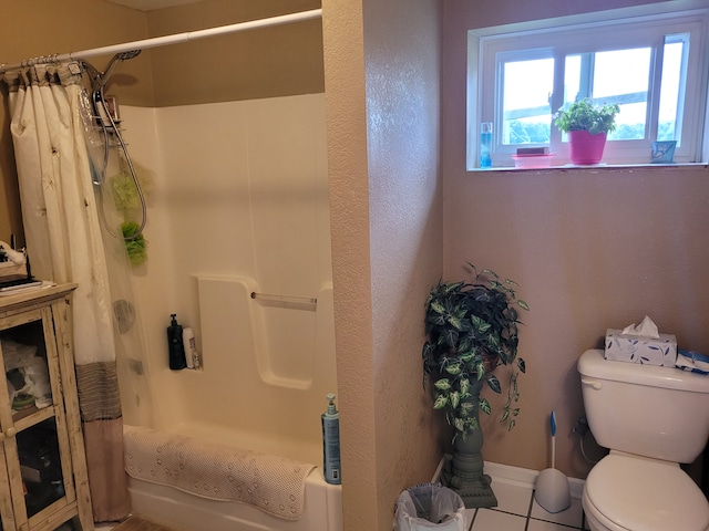 bathroom with toilet, shower / tub combo, and tile patterned flooring