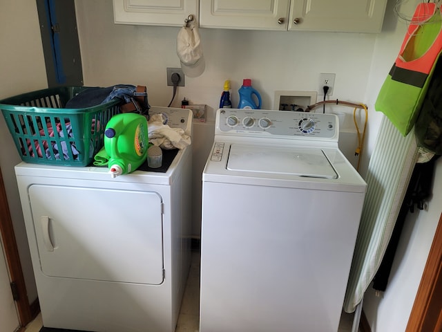 laundry area with washer and dryer and cabinets