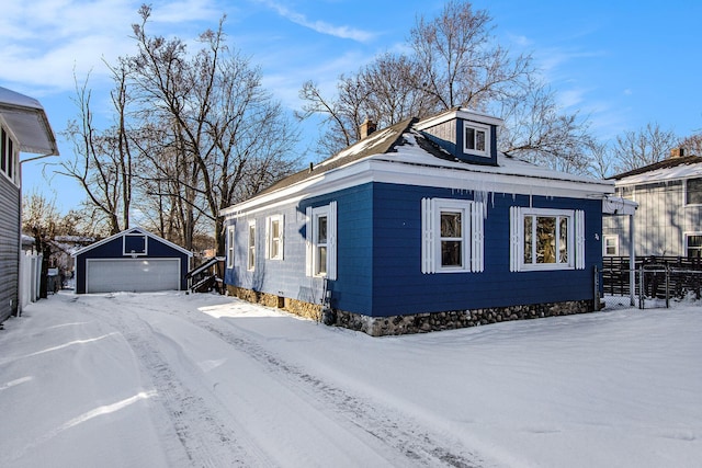 view of front of house with a garage and an outdoor structure