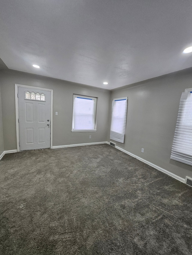 foyer with dark carpet