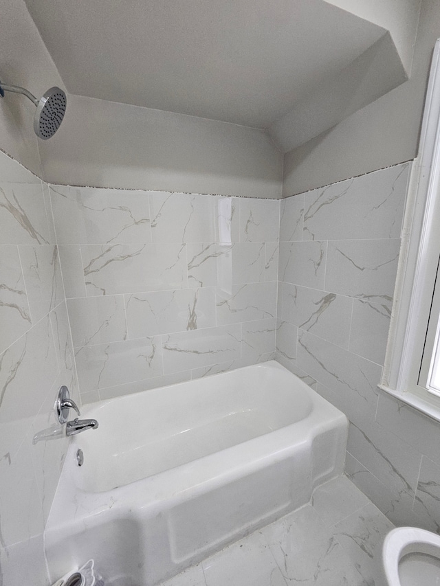 bathroom featuring toilet and shower / tub combination