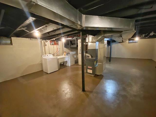 basement with washer / dryer and heating unit