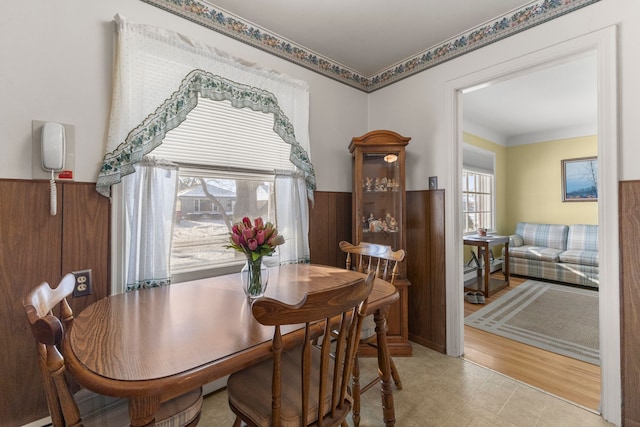 dining room featuring wooden walls