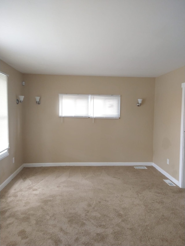 empty room with light colored carpet