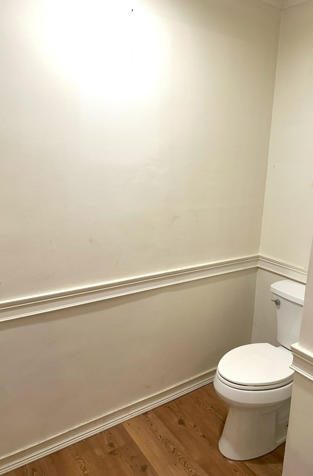 bathroom featuring hardwood / wood-style floors and toilet