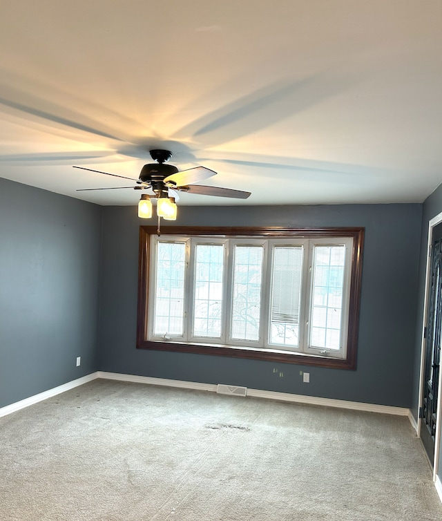 carpeted empty room with ceiling fan