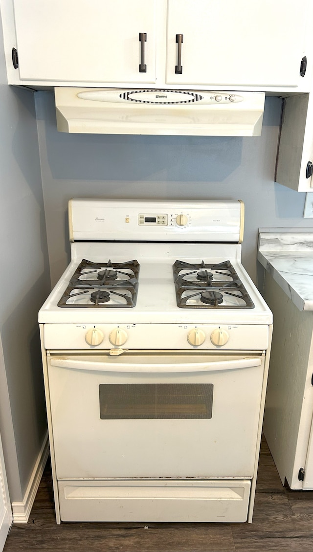 kitchen featuring extractor fan, white cabinets, gas range gas stove, and dark wood-type flooring