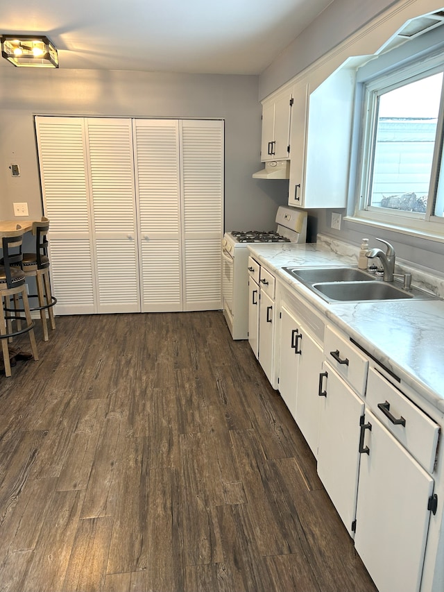 kitchen featuring sink, white cabinets, white range with gas cooktop, and dark wood-type flooring