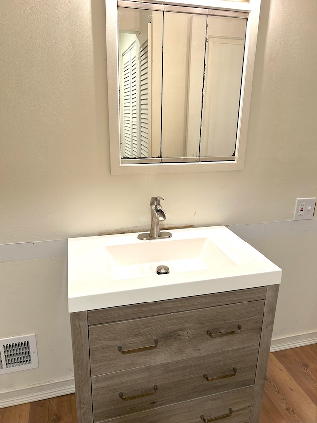 bathroom featuring wood-type flooring and vanity