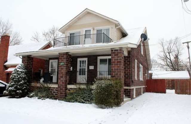 view of front facade with a balcony and covered porch