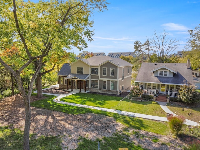 view of front of house with a front yard and covered porch