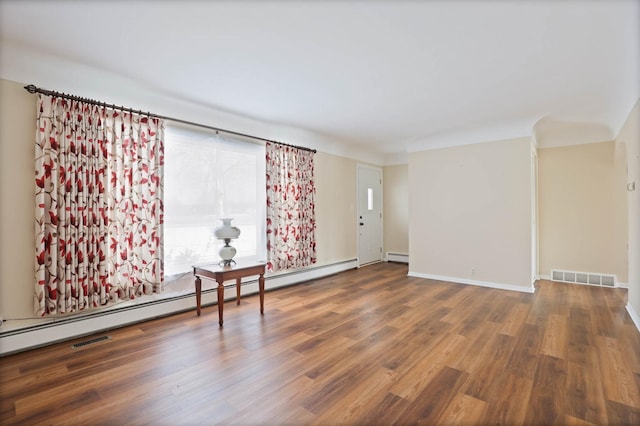 9800 Gera Rd, Birch Run, MI 48415 - empty room with a baseboard radiator, wood finished floors, a baseboard heating unit, and baseboards