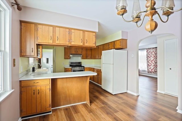 9800 Gera Rd, Birch Run, MI 48415 - kitchen with freestanding refrigerator, stainless steel range with gas cooktop, a sink, arched walkways, and dark wood finished floors