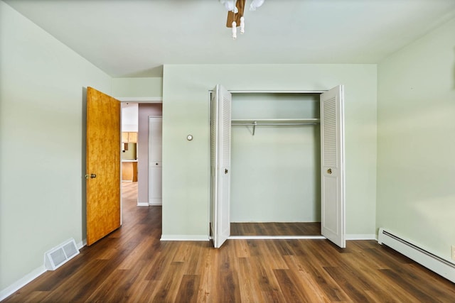 9800 Gera Rd, Birch Run, MI 48415 - unfurnished bedroom with baseboard heating, wood finished floors, a closet, and baseboards
