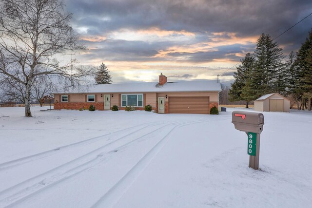 single story home featuring a storage shed