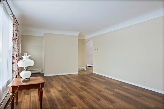 9800 Gera Rd, Birch Run, MI 48415 - empty room featuring a baseboard radiator, arched walkways, dark wood-style flooring, and baseboards