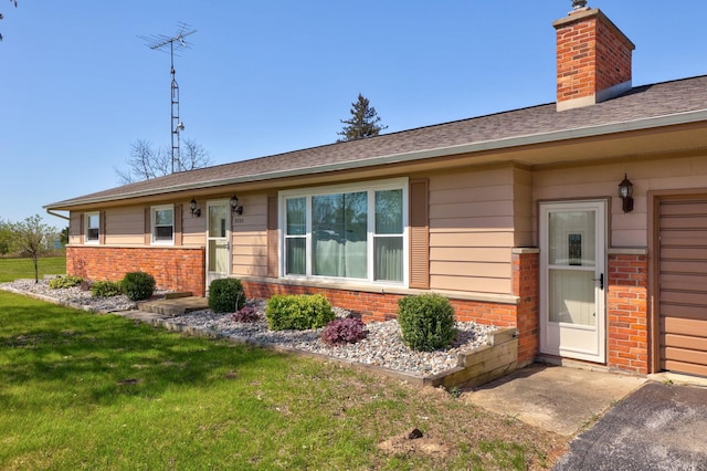 9800 Gera Rd, Birch Run, MI 48415 - ranch-style home featuring a chimney, brick siding, a front lawn, and a shingled roof