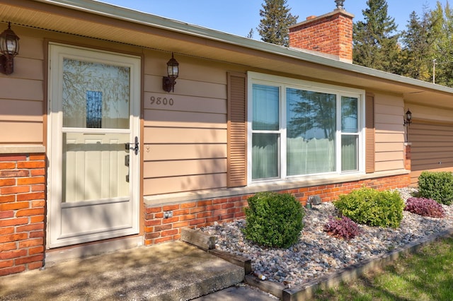 9800 Gera Rd, Birch Run, MI 48415 - doorway to property with brick siding and a chimney