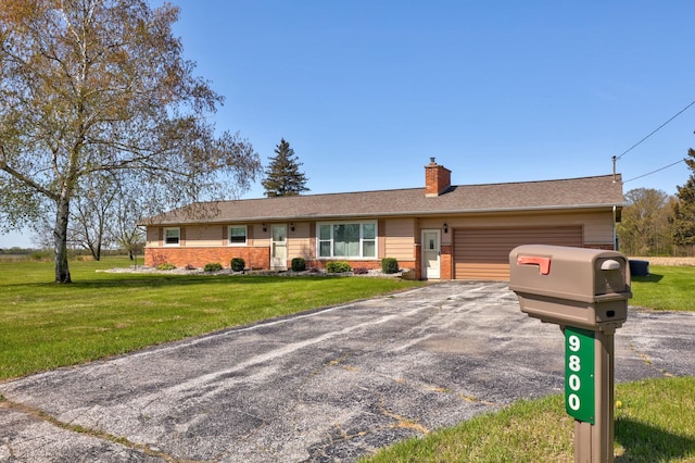 9800 Gera Rd, Birch Run, MI 48415 - ranch-style house with a garage, a front lawn, a chimney, and asphalt driveway