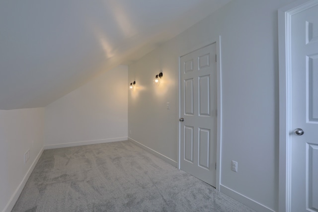 additional living space with lofted ceiling and light colored carpet