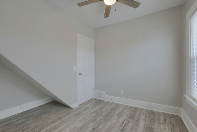 empty room with ceiling fan and light wood-type flooring